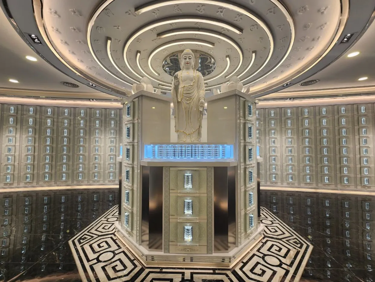 Columbarium suite with a central Buddha statue and illuminated niches